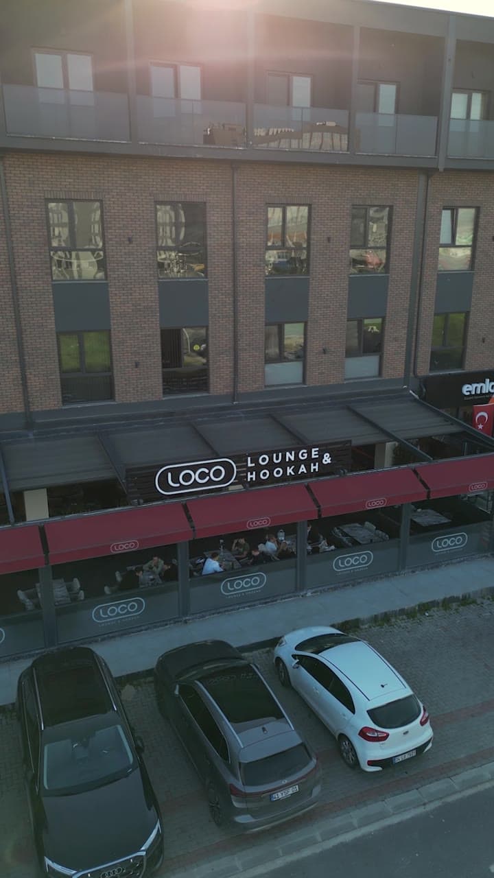 Aerial view of a commercial facade with lounge signage